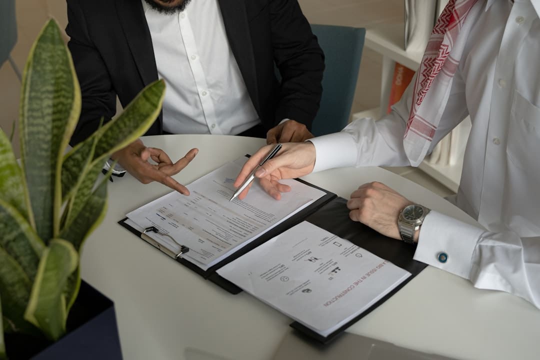 ohio support animal. Two men sitting at a table with papers and a pen