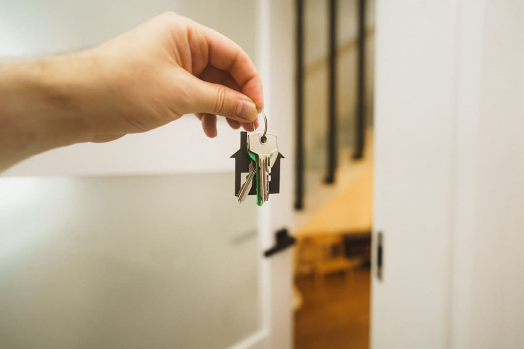 renters insurance — A hand holding a key to a door