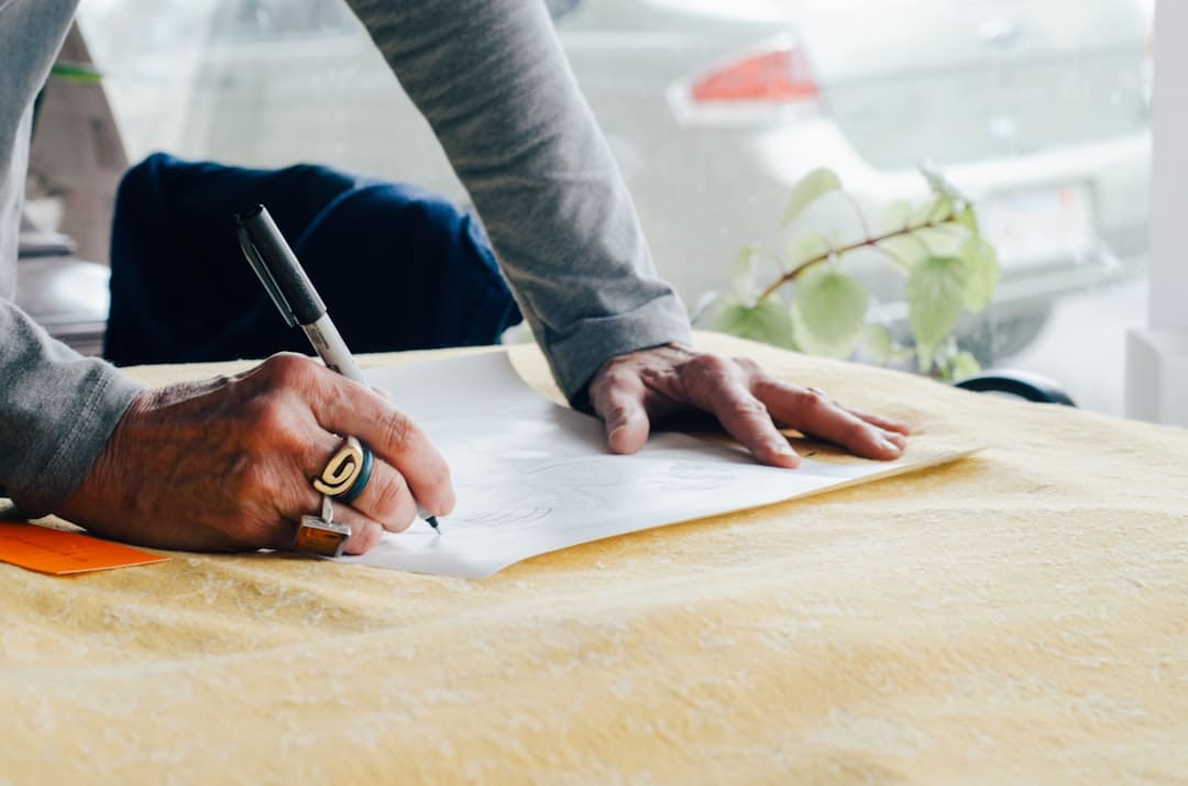 arizona support animal — person writing on white plain paper on the table photography