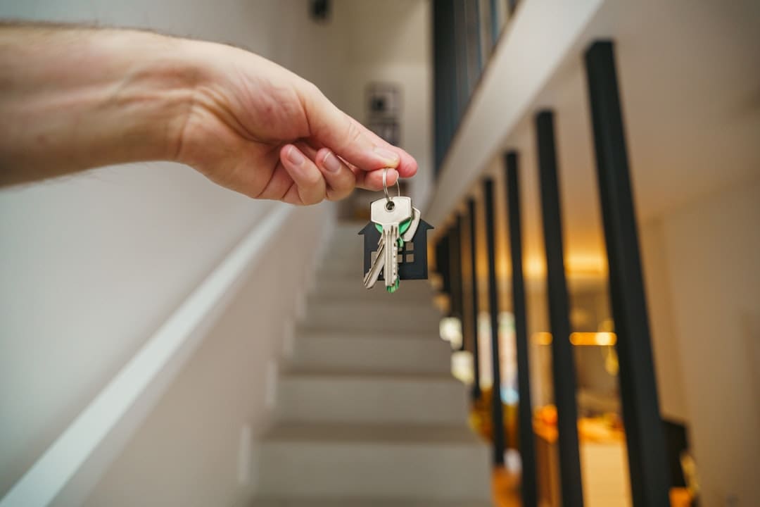 housing discrimination complaint — Here's a possible caption: keys being held in front of a staircase.