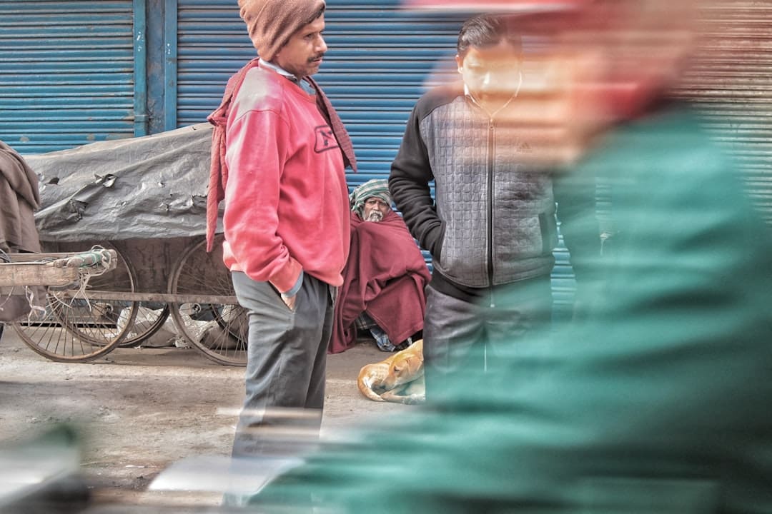 michigan support animal — Two men talking on a street with a cart.