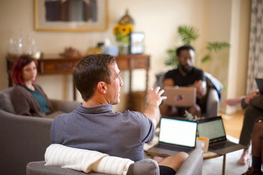 support animal tenant protections — man in gray sweater sitting on couch