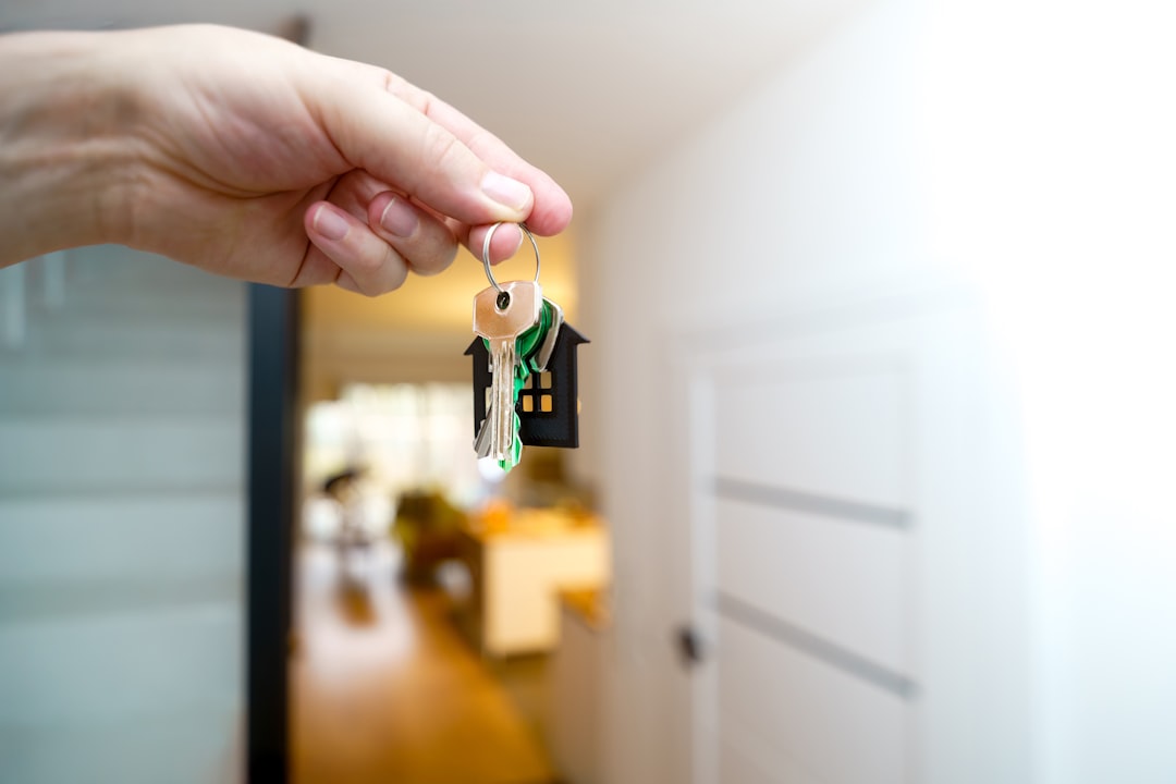 renters insurance support animals — Holding house keys in front of the entrance